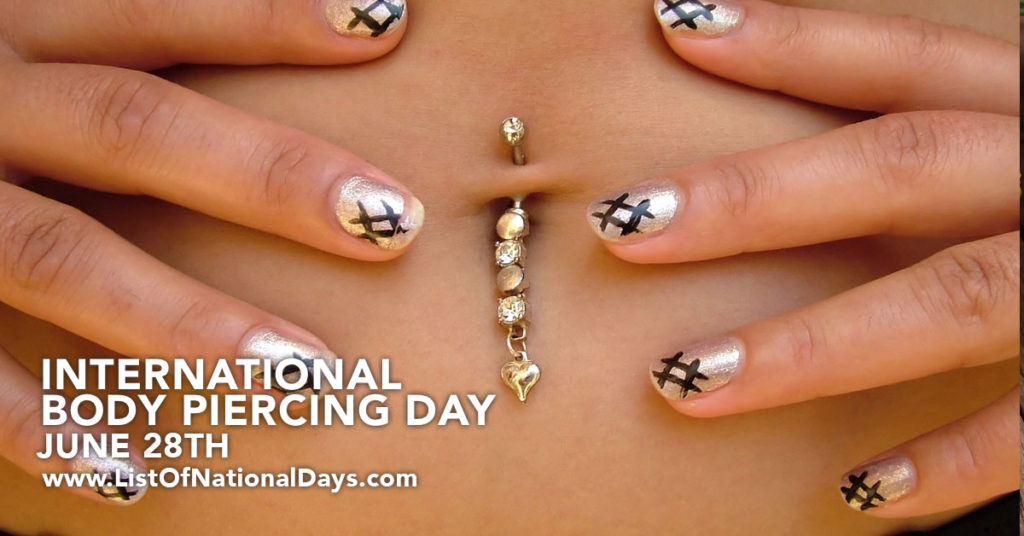 Close up of a woman's navel jewelry piercing made of gold and diamonds with a small heart at the end.