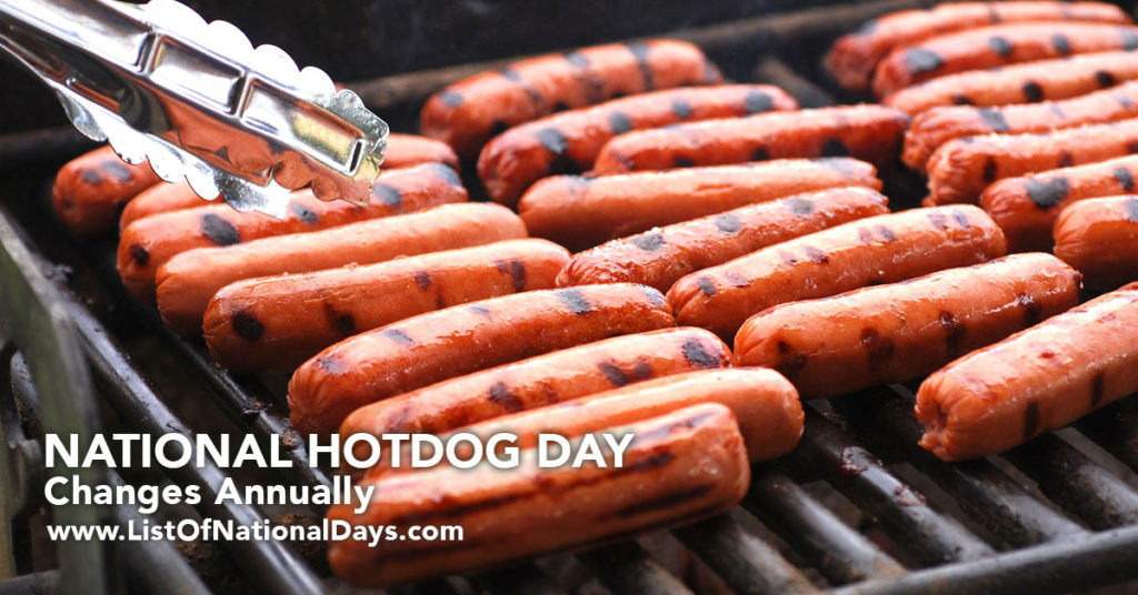 24 hotdogs on a grill.
