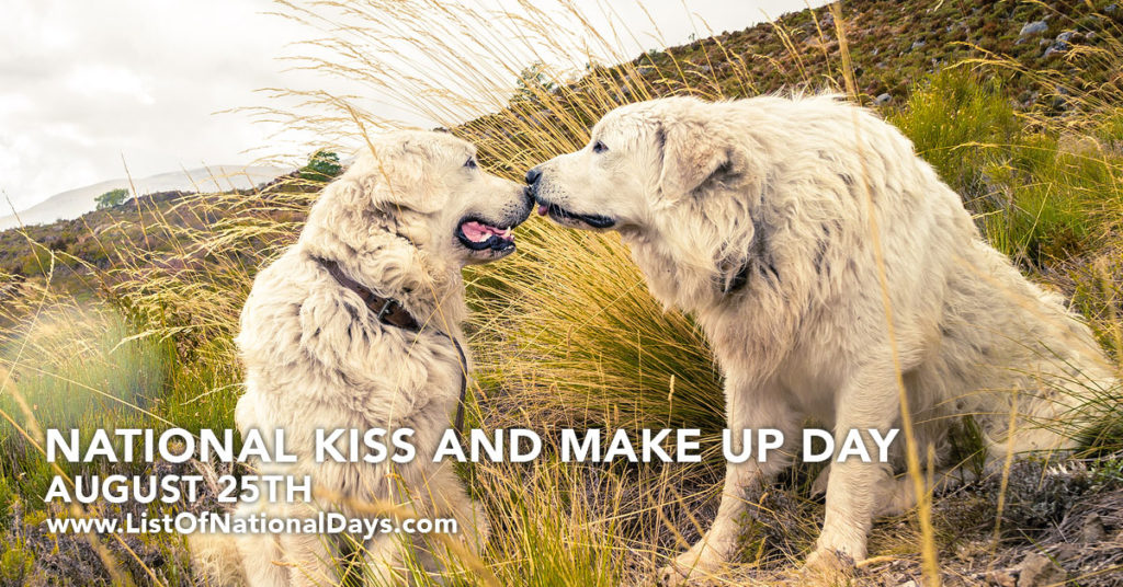 Two white dogs kissing.